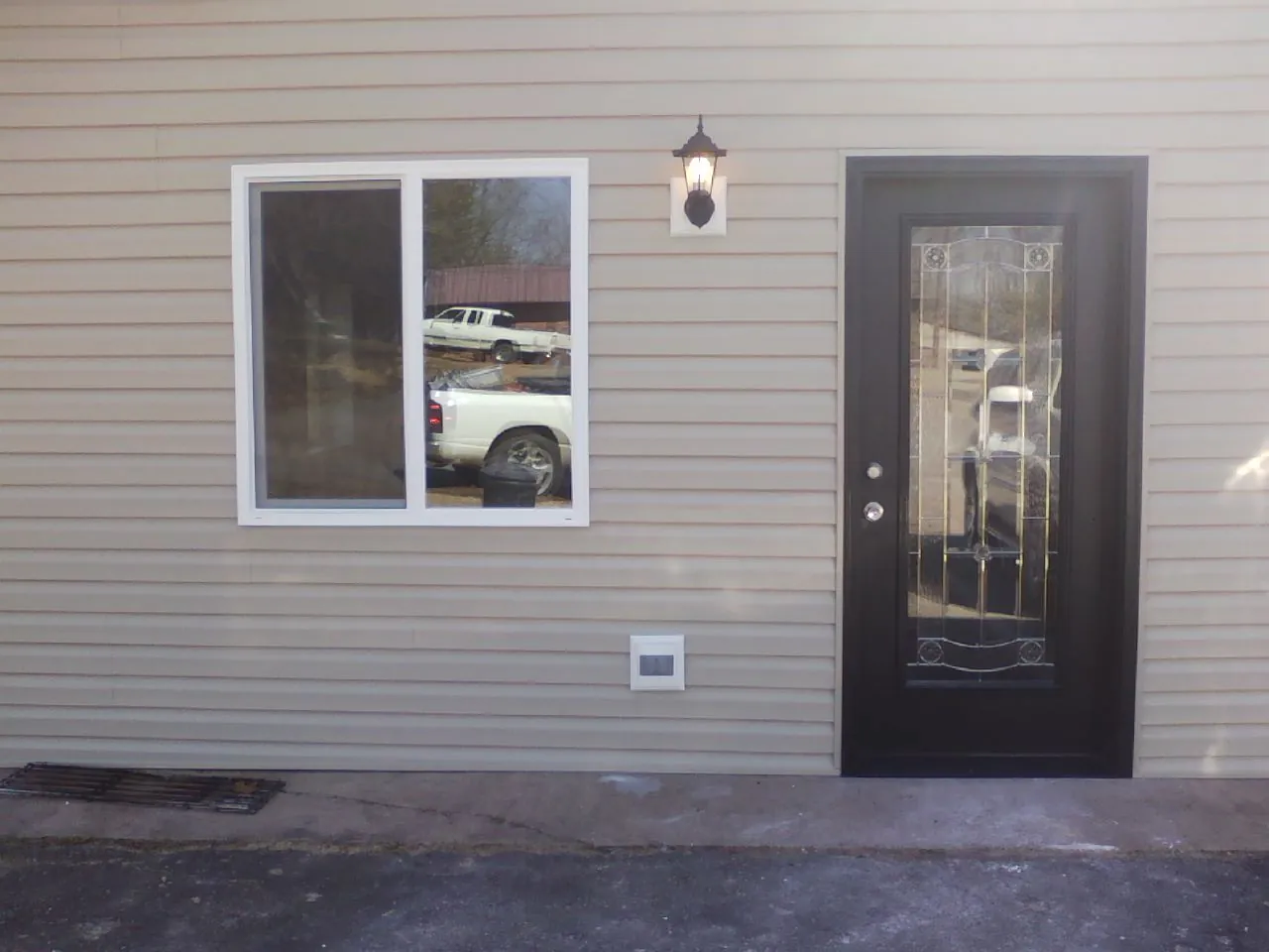 New siding, window and entry door on the side of an addition in El Campo